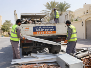 Scrap buyer in Al Wakrah Qatar collecting metal scrap from residential villa, workers loading aluminum frames, steel and copper scrap onto pickup truck